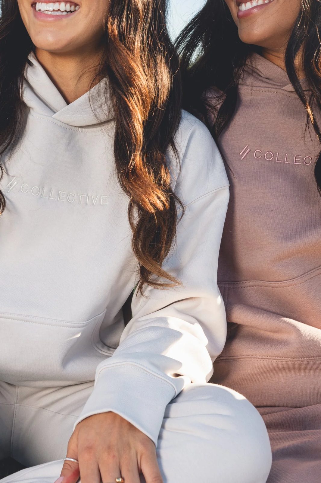 Co//Lab Collective apparel, cream hoodie shot on stadium bleachers