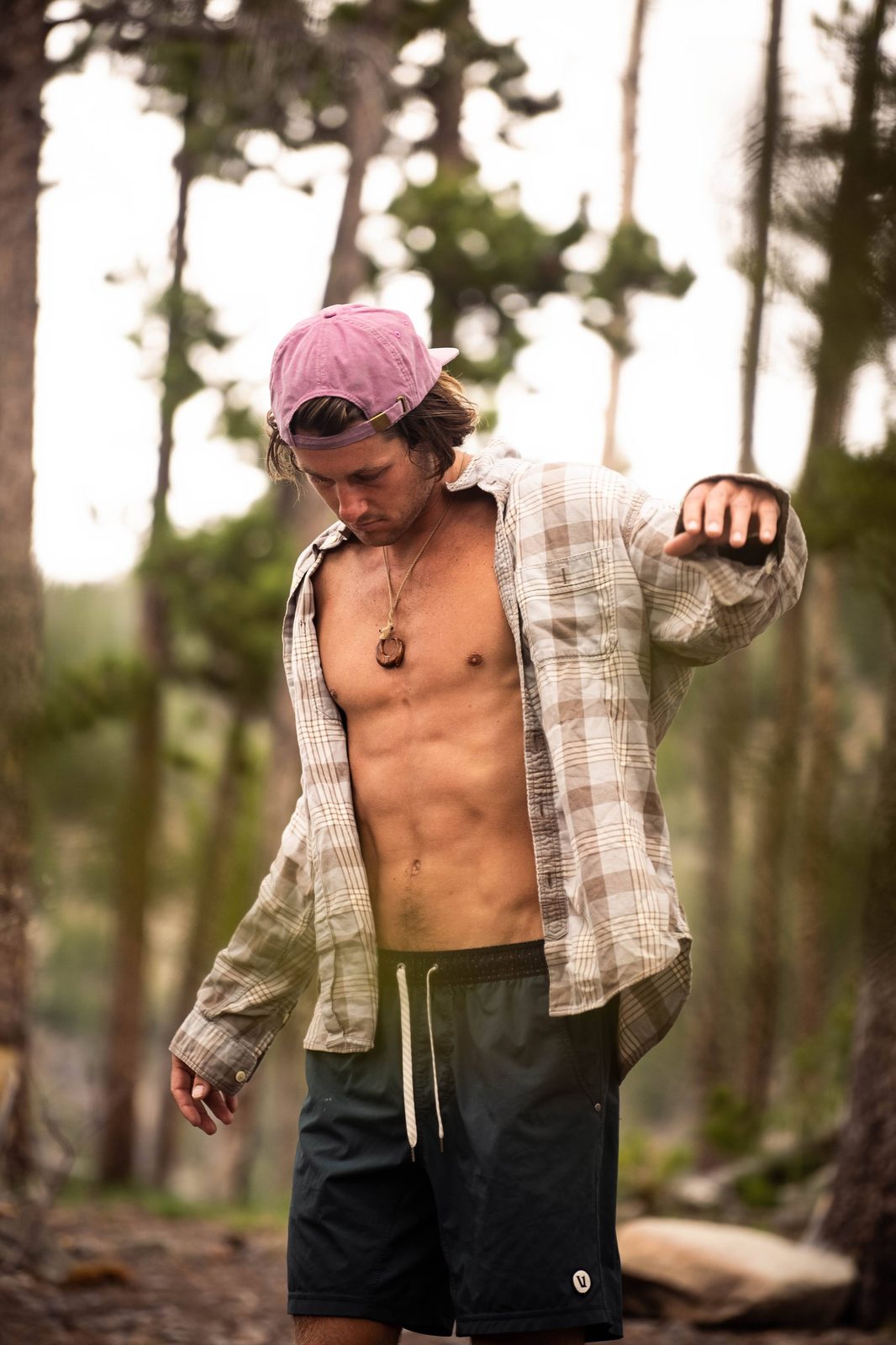 Man wearing pink Rora Basics cap backwards outdoors